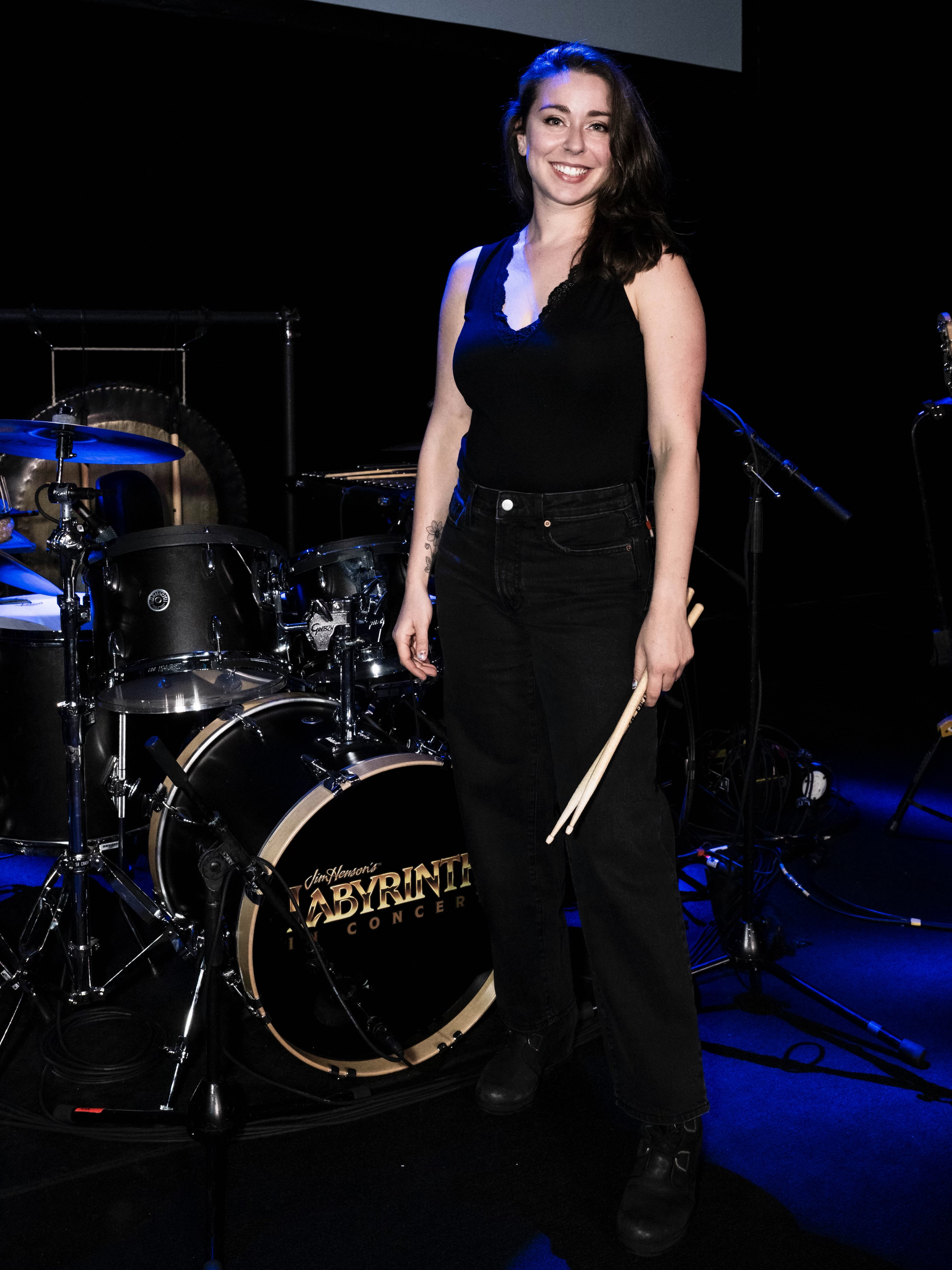 Jessie posing in front of Labyrinth drum setup